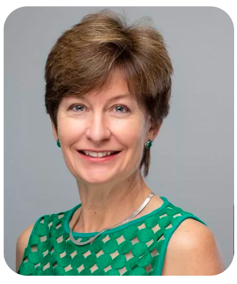 Jennifer Moser smiles in a professional head shot. She is wearing a green sleeveless blouse and green earrings.