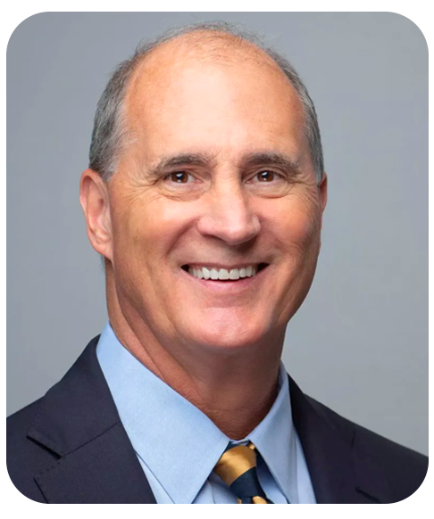 Craig Moser smiles warmly into the camera wearing a suit and tie.